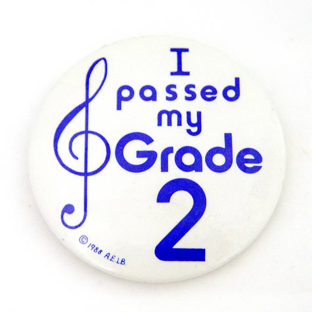 I Passed My Grade 2 Badge 55mm Ø - White Circular with Blue and Red Printing, Made in England